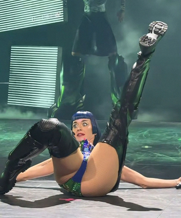 Performer in concert costume on stage, mid-dance with theatrical expression, showcasing energetic tour debut dance moves. Performer in concert costume on stage, mid-dance with theatrical expression, showcasing energetic tour debut dance moves.