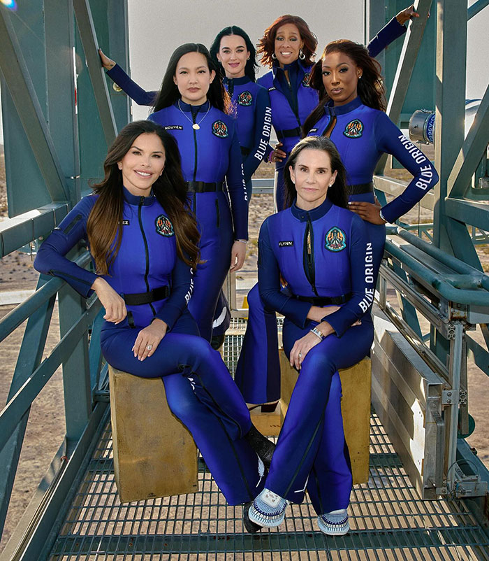 Blue Origin crew posing in blue flight suits, smiling before space mission. Blue Origin crew posing in blue flight suits, smiling before space mission.