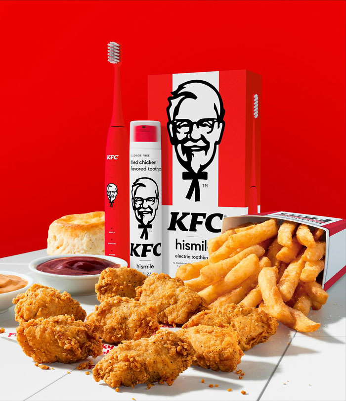 KFC toothpaste with 11 herbs and spices flavor, alongside fried chicken, fries, sauces, and biscuit in a vivid red setting. KFC toothpaste with 11 herbs and spices flavor, alongside fried chicken, fries, sauces, and biscuit in a vivid red setting.