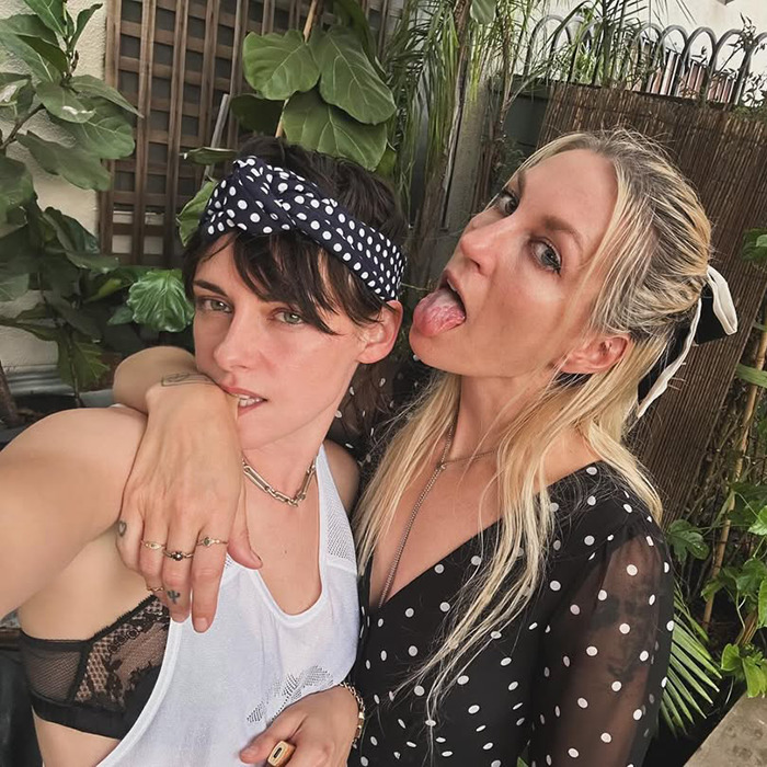 Lovebirds posing together outdoors, showcasing PDA with lush greenery in the background. Lovebirds posing together outdoors, showcasing PDA with lush greenery in the background.