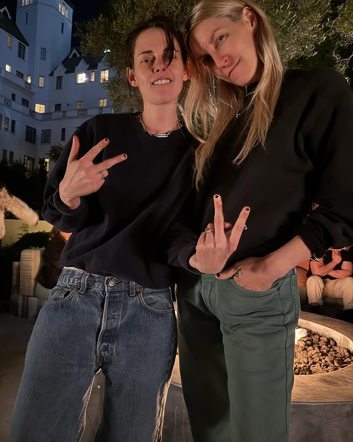 Lovebirds Kristen Stewart and Dylan Meyer posing together outdoors, showing peace signs with casual outfits. Lovebirds Kristen Stewart and Dylan Meyer posing together outdoors, showing peace signs with casual outfits.
