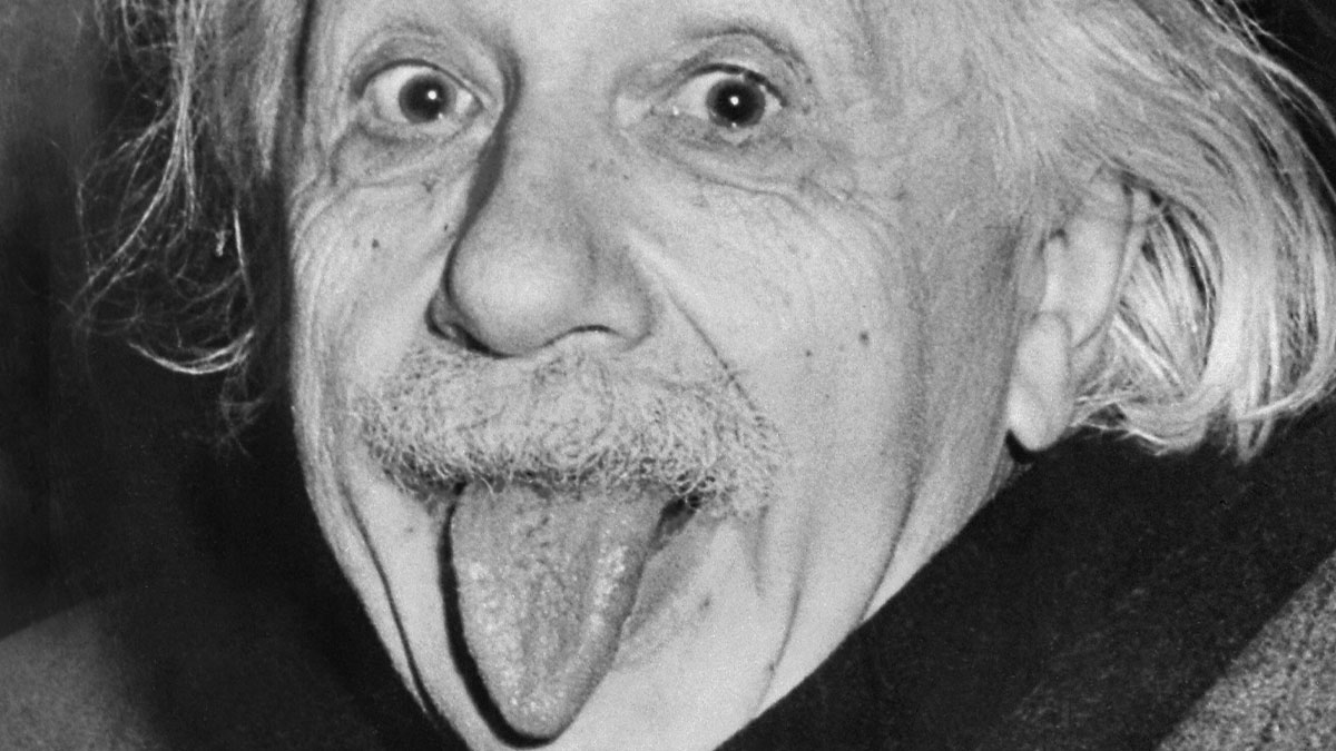 Albert Einstein sticking out his tongue, a memorable image symbolizing last-minute decisions that impacted history.