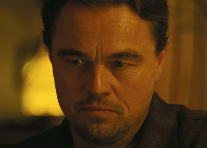 A person with a serious expression, in a dimly lit setting, highlighting a new look possibly linked to a midlife crisis. A person with a serious expression, in a dimly lit setting, highlighting a new look possibly linked to a midlife crisis.