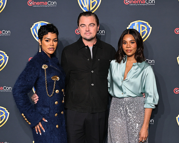 Leonardo DiCaprio on Las Vegas red carpet, showcasing new look with two women at a CinemaCon event. Leonardo DiCaprio on Las Vegas red carpet, showcasing new look with two women at a CinemaCon event.
