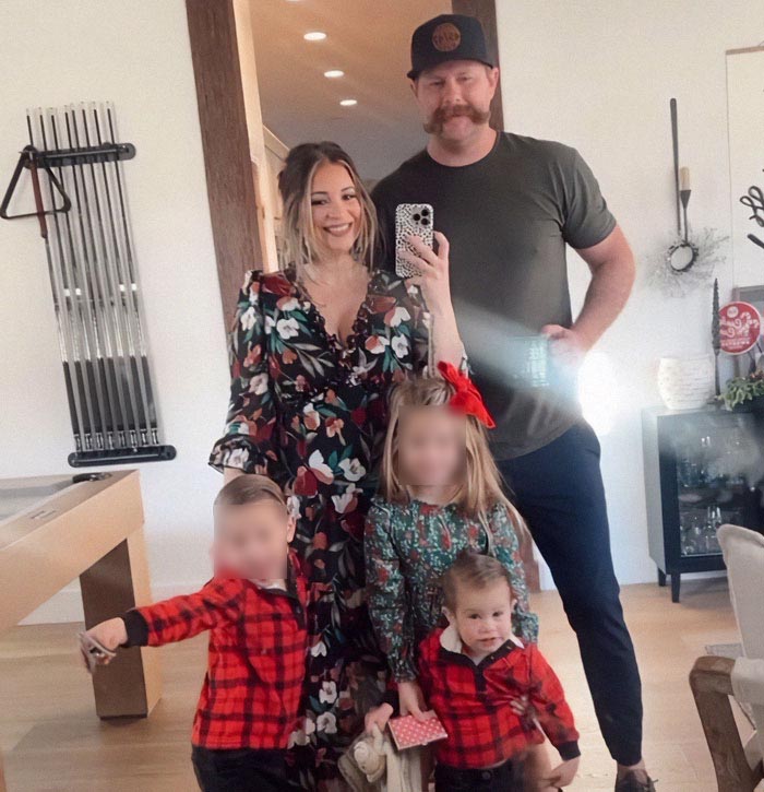 Family of parenting influencer in their home with children, capturing a mirror selfie. Family of parenting influencer in their home with children, capturing a mirror selfie.