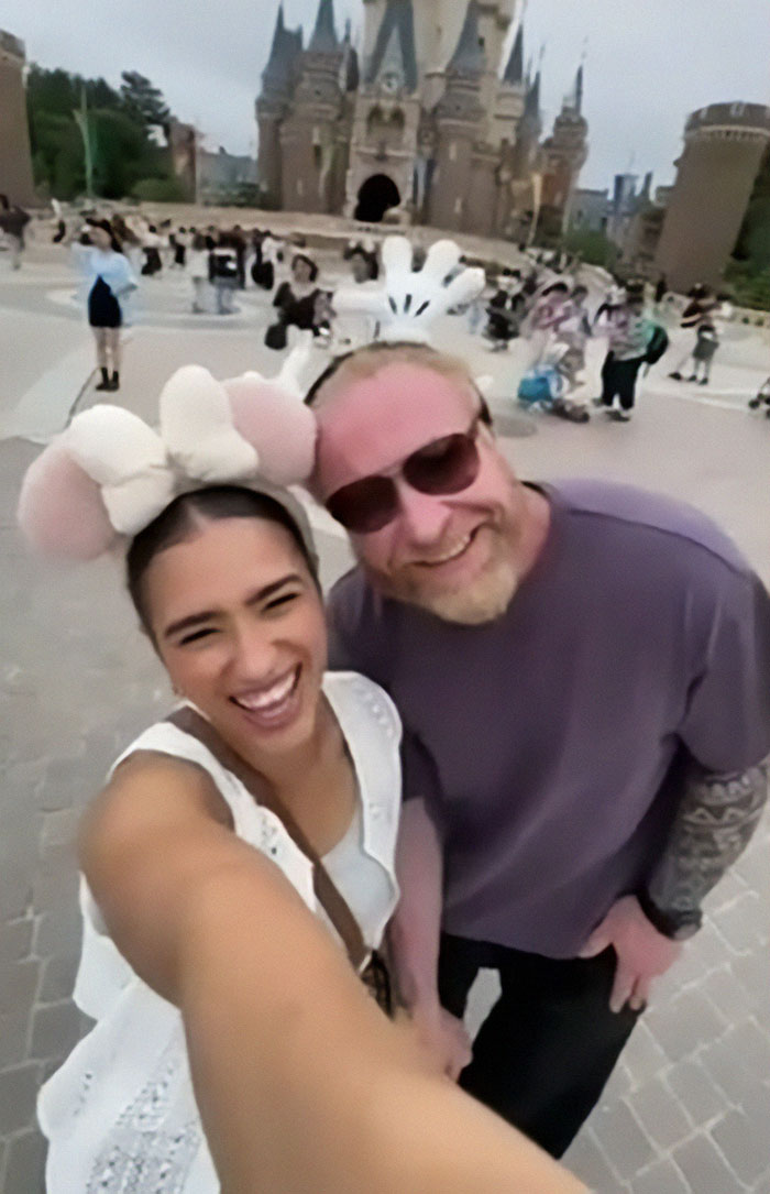 Couple smiling on vacation in front of a castle. Couple smiling on vacation in front of a castle.