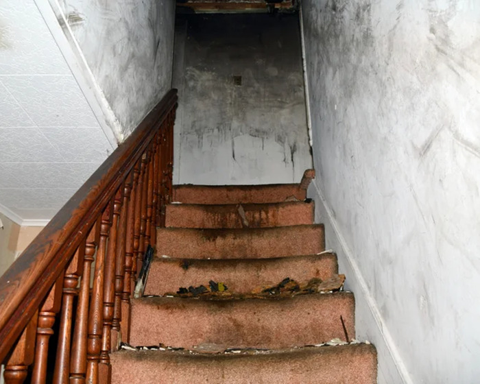 Dilapidated staircase in a gloomy, neglected house, symbolizing captivity and hardship faced by man for 20 years. Dilapidated staircase in a gloomy, neglected house, symbolizing captivity and hardship faced by man for 20 years.