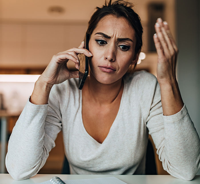 Woman on phone looking frustrated about wedding menu mishap. Woman on phone looking frustrated about wedding menu mishap.