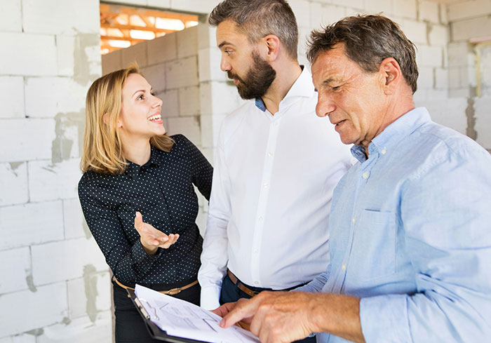 Group discussing construction with documents, related to complaint about an illegal shed. Group discussing construction with documents, related to complaint about an illegal shed.