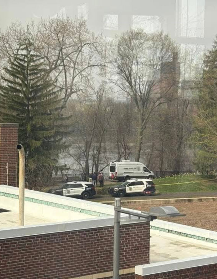 Police vehicles and crime scene unit at New England murder investigation site near wooded area. Police vehicles and crime scene unit at New England murder investigation site near wooded area.