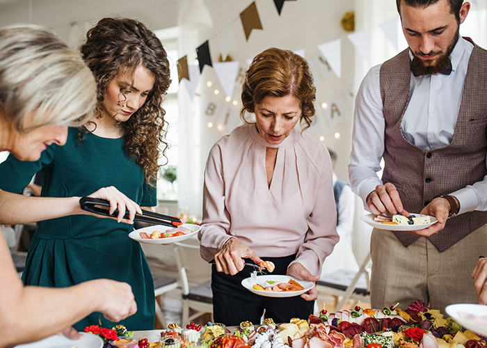 Guests serving from a vegetarian buffet at a wedding reception. Guests serving from a vegetarian buffet at a wedding reception.