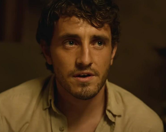 Actor in a dimly lit scene, representing casting choices in Beatles biopic debate. Actor in a dimly lit scene, representing casting choices in Beatles biopic debate.