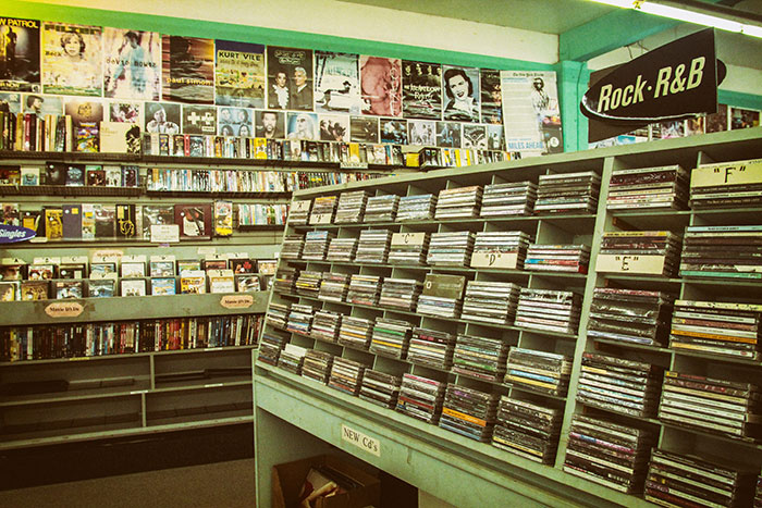 A retro music store showcasing CDs and vinyl, highlighting the magic of physical media. A retro music store showcasing CDs and vinyl, highlighting the magic of physical media.