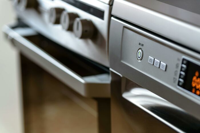 Close-up of a modern kitchen stove, representing adult habits in maintaining household appliances.