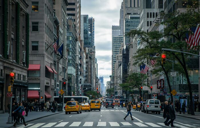 Bustling New York City street with yellow taxis, a top US travel destination in summer.