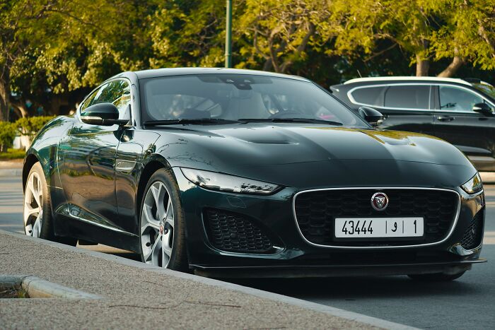 Luxury car parked on a sunny day, highlighting the theme of pretending to be rich.