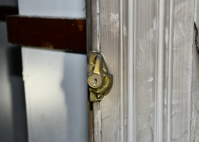 Securely locked door in a dimly lit room of a horror house, highlighting eerie conditions. Securely locked door in a dimly lit room of a horror house, highlighting eerie conditions.