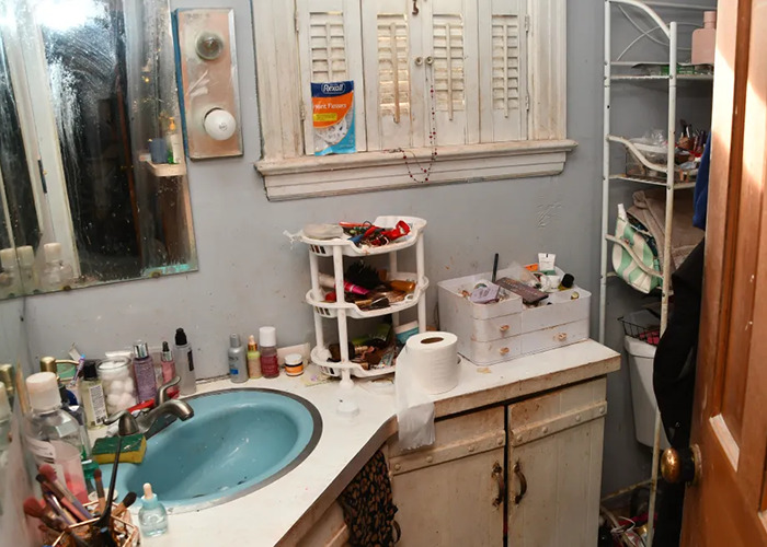 Cluttered bathroom in horror house linked to "evil" mom case, showing sink and toiletries in disarray. Cluttered bathroom in horror house linked to "evil" mom case, showing sink and toiletries in disarray.