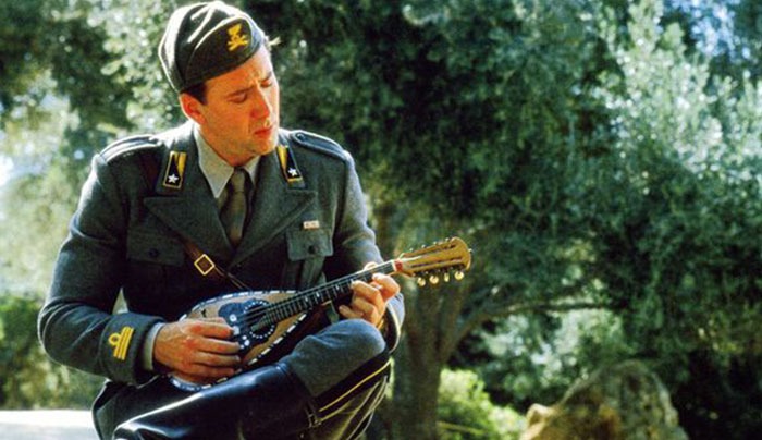 Actor in military uniform plays mandolin, representing casting mistakes in Hollywood's past decisions.