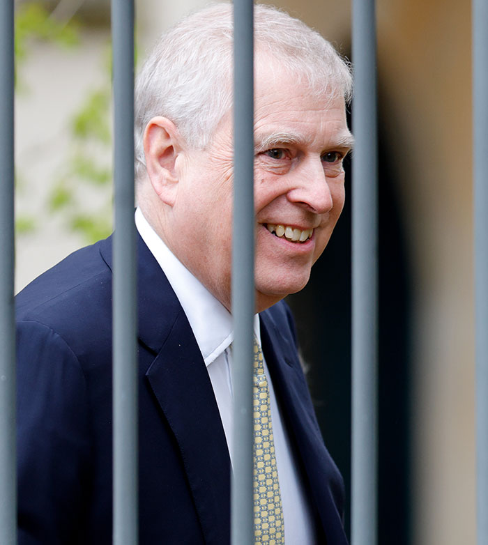 Smiling man in a suit behind bars, related to accuser's claims and police contradiction. Smiling man in a suit behind bars, related to accuser's claims and police contradiction.