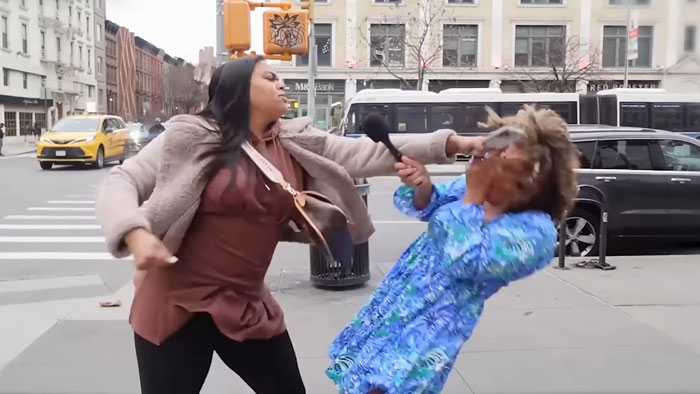 Pro-life activist attacked during street interview, microphone in hand, on urban sidewalk with traffic in background. Pro-life activist attacked during street interview, microphone in hand, on urban sidewalk with traffic in background.
