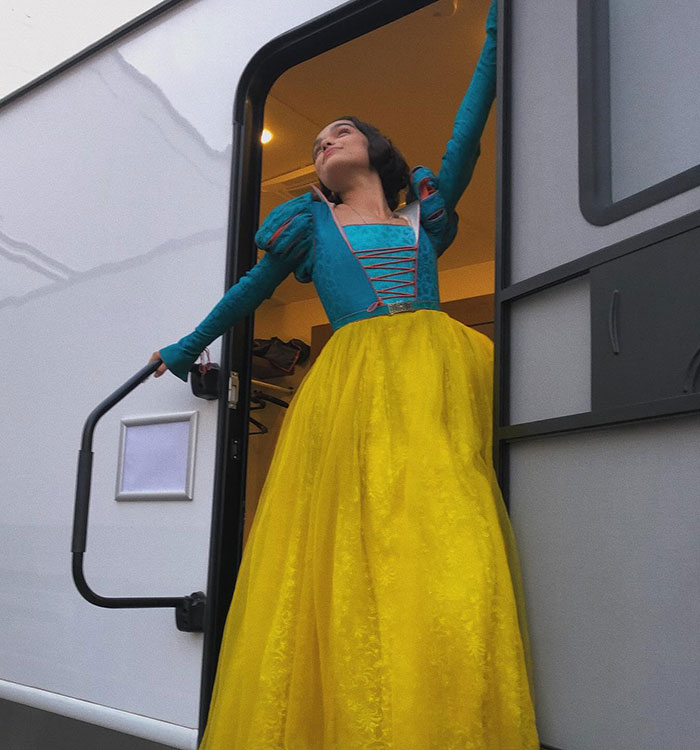 Individual in a costume standing in a trailer doorway, posing thoughtfully. Individual in a costume standing in a trailer doorway, posing thoughtfully.