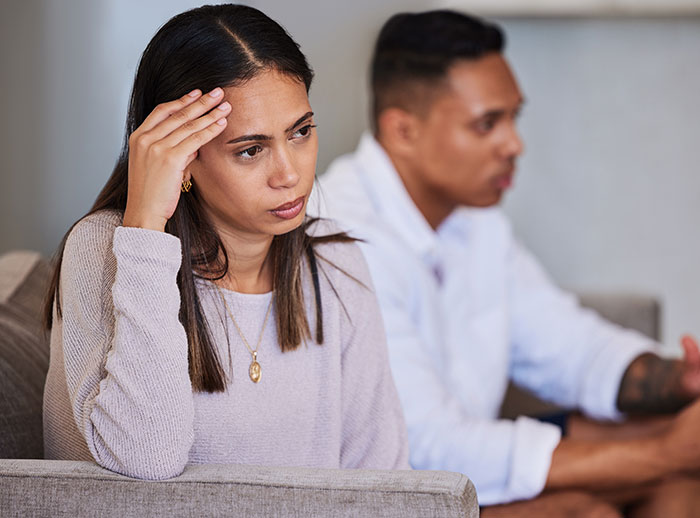 Concerned parents discussing daughter's eating disorder at home. Concerned parents discussing daughter's eating disorder at home.