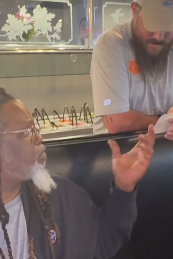 Restaurant owner gestures passionately while discussing customer feedback. Restaurant owner gestures passionately while discussing customer feedback.