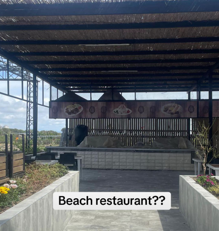 Outdoor seating at a 5-star resort in Turkey, appearing empty with a sign questioning "Beach restaurant?? Outdoor seating at a 5-star resort in Turkey, appearing empty with a sign questioning "Beach restaurant??