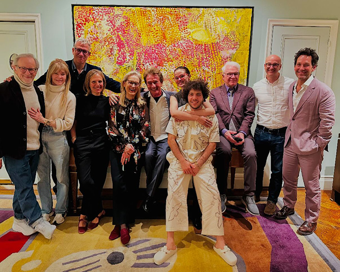 Group of people posing indoors with colorful art, including Benny Blanco, related to Selena Gomez. Group of people posing indoors with colorful art, including Benny Blanco, related to Selena Gomez.