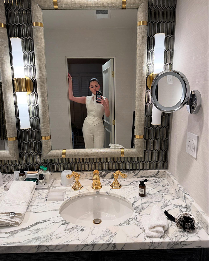 Bathroom selfie captures intimate glimpse, with reflection in stylish mirror, items visible on marble sink. Bathroom selfie captures intimate glimpse, with reflection in stylish mirror, items visible on marble sink.