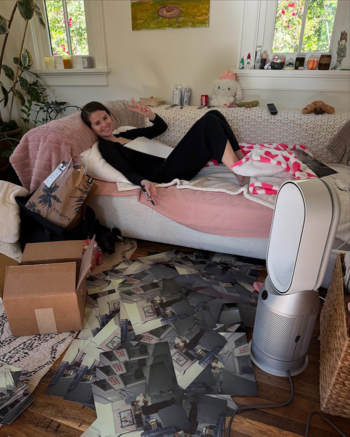 Woman relaxing on a sofa with photos on the floor, offering a glimpse into her intimate life. Woman relaxing on a sofa with photos on the floor, offering a glimpse into her intimate life.