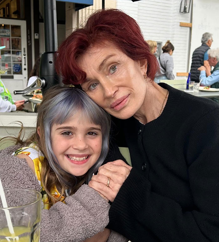Woman with red hair and child with colorful hair smiling at a cafe, linked to Ozempic feet keyword discussion. Woman with red hair and child with colorful hair smiling at a cafe, linked to Ozempic feet keyword discussion.