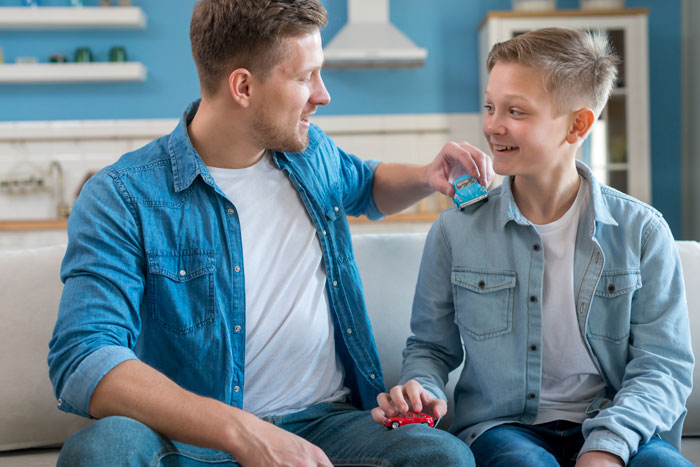 Father and son in casual clothes playing together indoors, highlighting a moment related to son father grooming drama. Father and son in casual clothes playing together indoors, highlighting a moment related to son father grooming drama.