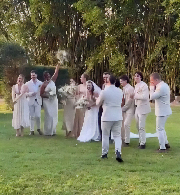 Wedding party joyfully celebrating miracle survivor's special day outdoors in elegant attire. Wedding party joyfully celebrating miracle survivor's special day outdoors in elegant attire.