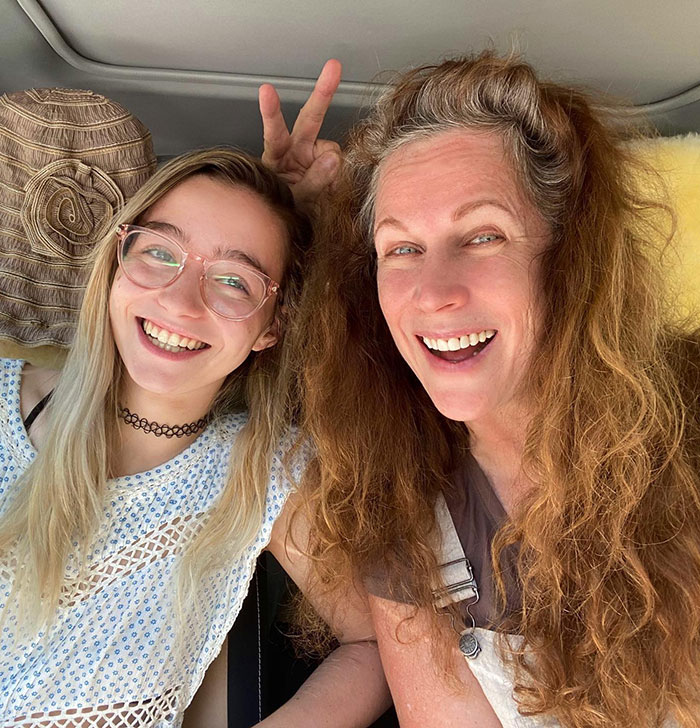 Two smiling women in a car, one making a peace sign, associated with the former child star mystery. Two smiling women in a car, one making a peace sign, associated with the former child star mystery.