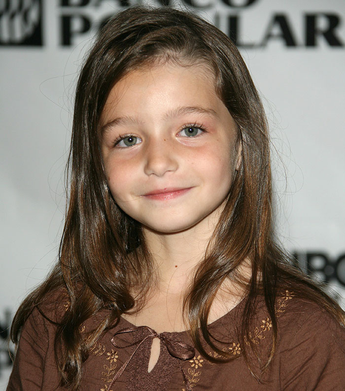 Child star Sophie Nyweide in a brown dress at a public event, smiling with her long hair down. Child star Sophie Nyweide in a brown dress at a public event, smiling with her long hair down.