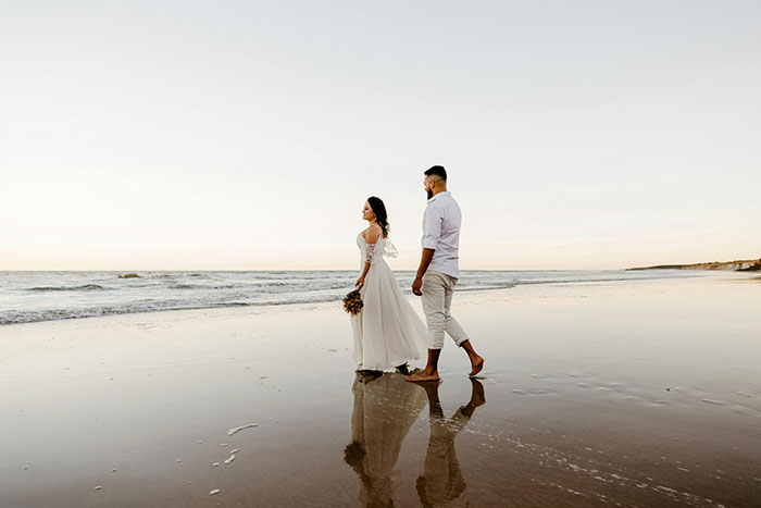 A couple walking on a serene beach, symbolizing a story of karma and life reflections. A couple walking on a serene beach, symbolizing a story of karma and life reflections.