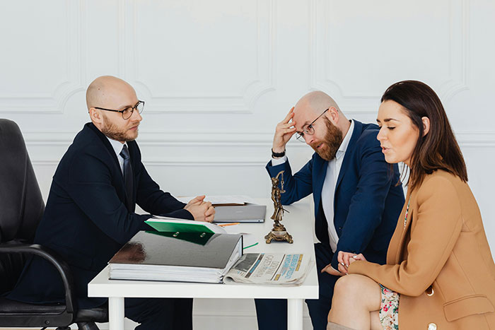 Three people in a meeting discussing serious issues, with a focus on consequences of a stepmom's past affair. Three people in a meeting discussing serious issues, with a focus on consequences of a stepmom's past affair.