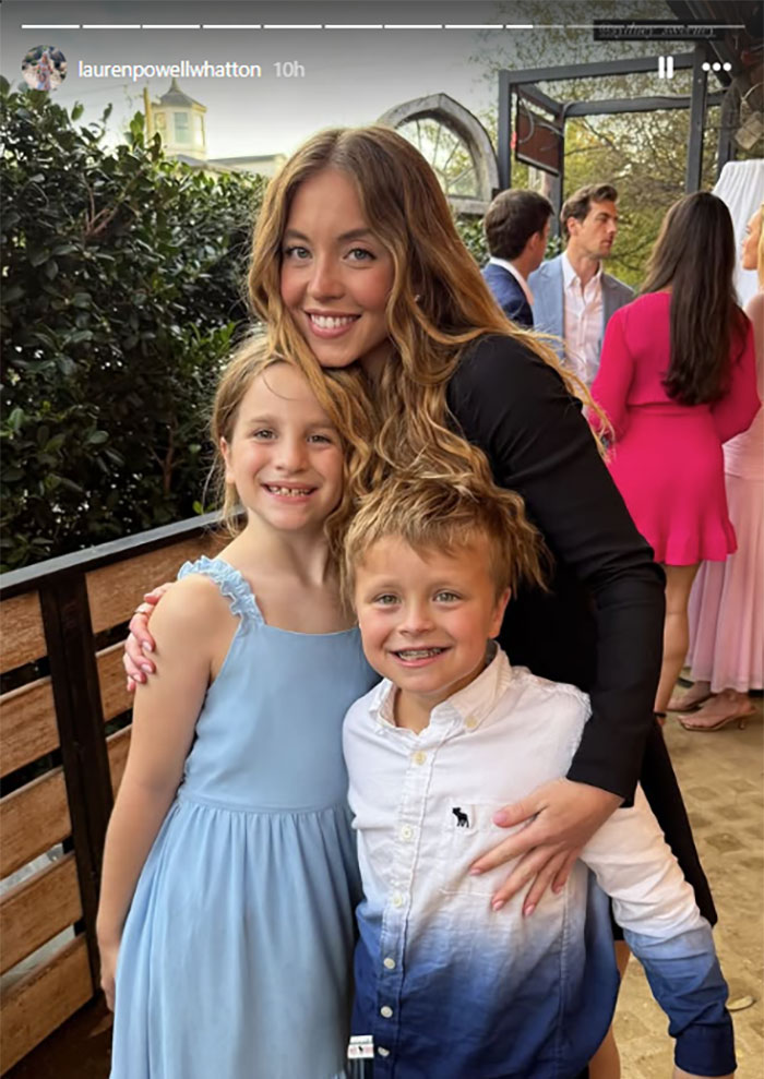 Sydney Sweeney smiling with children at Glen Powell's sister's wedding. Sydney Sweeney smiling with children at Glen Powell's sister's wedding.