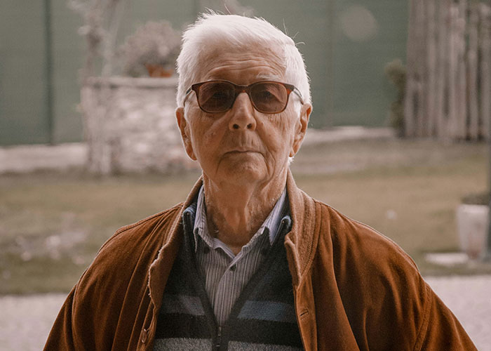 Elderly man with sunglasses outdoors, embodying grandpa's defiant spirit. Elderly man with sunglasses outdoors, embodying grandpa's defiant spirit.