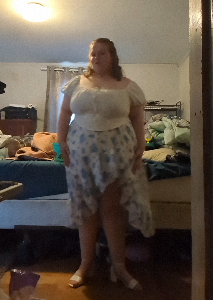 Teen in prom dress stands in room, showcasing viral story prompting internet support. Teen in prom dress stands in room, showcasing viral story prompting internet support.