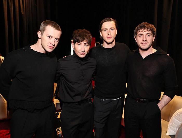 Actors posing for a Beatles biopic casting, sparking mixed reactions among fans. Actors posing for a Beatles biopic casting, sparking mixed reactions among fans.