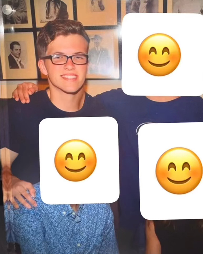 Young man in glasses smiling, surrounded by friends with emojis covering their faces, known for working out one side of his body. Young man in glasses smiling, surrounded by friends with emojis covering their faces, known for working out one side of his body.