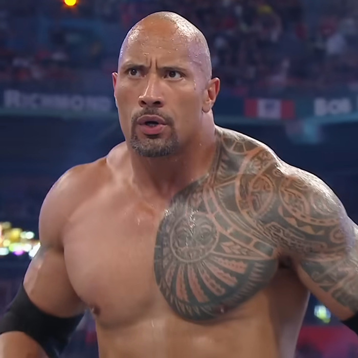 Bald man with Polynesian tattoo, intense expression, in a wrestling ring; sparks race confusion debate. Bald man with Polynesian tattoo, intense expression, in a wrestling ring; sparks race confusion debate.