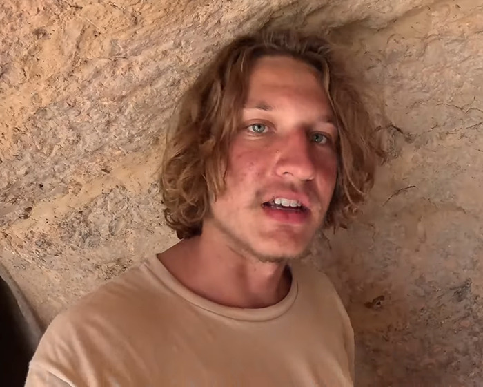 YouTuber posing in front of a rocky background, involved in isolated tribe Diet Coke incident. YouTuber posing in front of a rocky background, involved in isolated tribe Diet Coke incident.