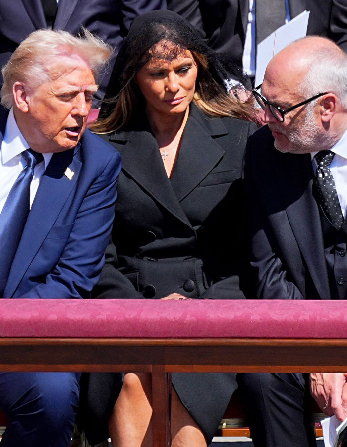 Melania in black, with Trump at a formal event. Lip reader speculation about whispered words at a significant gathering. Melania in black, with Trump at a formal event. Lip reader speculation about whispered words at a significant gathering.