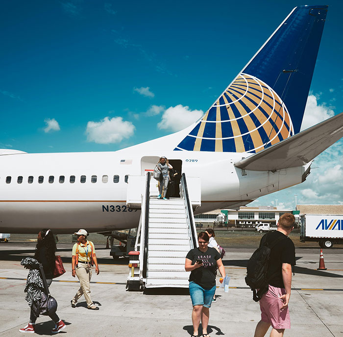 Airplane passengers disembarking, flight attendant controversy involving disabled passenger assistance. Airplane passengers disembarking, flight attendant controversy involving disabled passenger assistance.