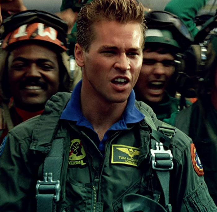 Legendary actor in a flight suit, appearing intense amidst a crowd, representing iconic Hollywood roles. Legendary actor in a flight suit, appearing intense amidst a crowd, representing iconic Hollywood roles.