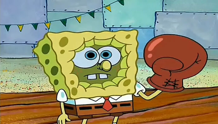SpongeBob holding a boxing glove in a playful scene, illustrating the art of insulting with humor.